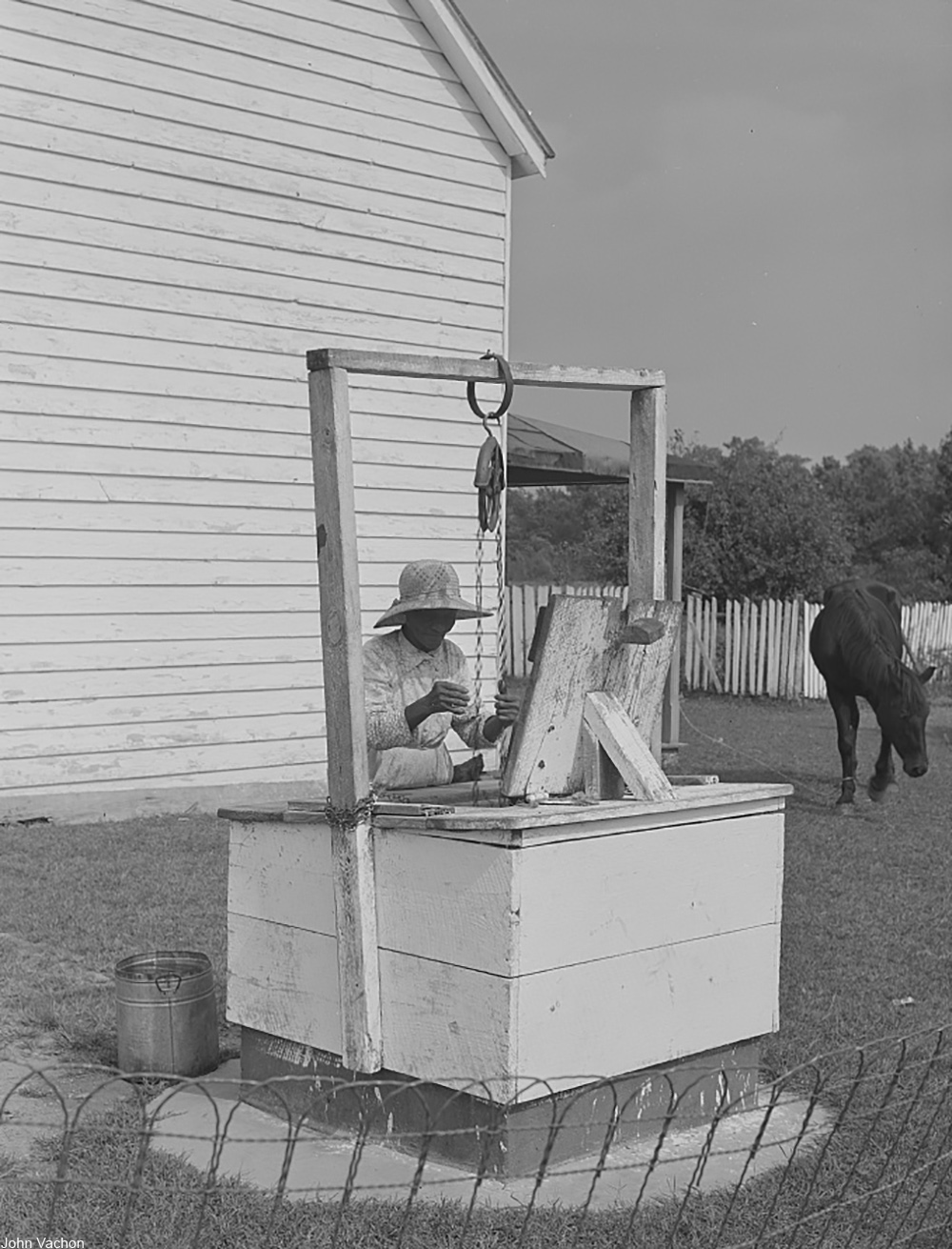 woman hauling water from a well during the Great Depression