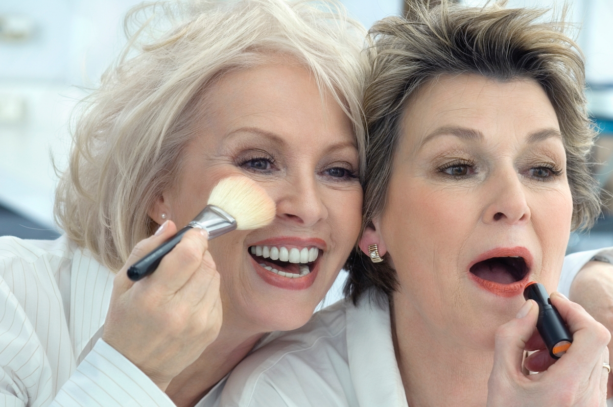 2 mature women applying makeup
