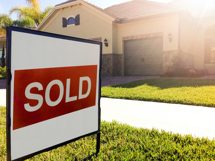 sold sign in front of house
