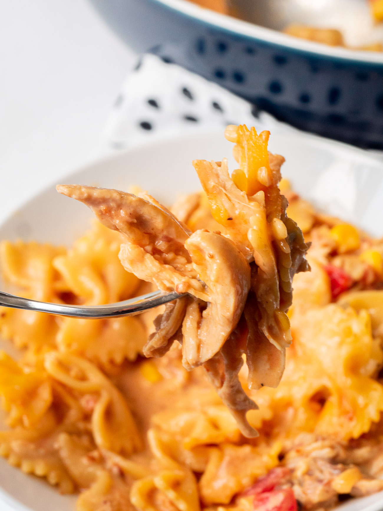 A bite of bbq chicken casserole on a fork