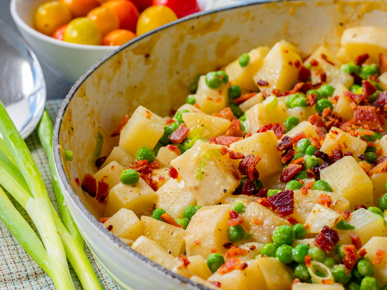 Close up of pot with potatoes, peas, and bacon
