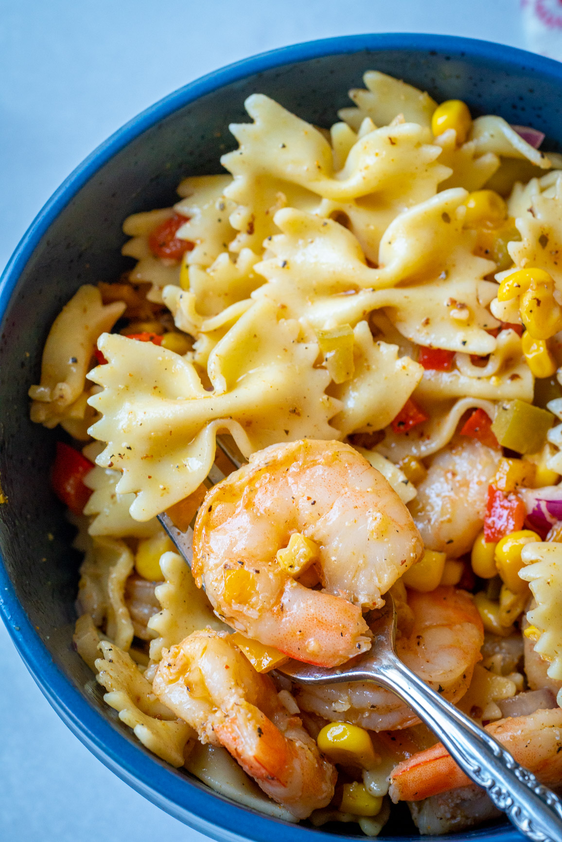 Top down of pasta salad and shrimp in a serving bowl