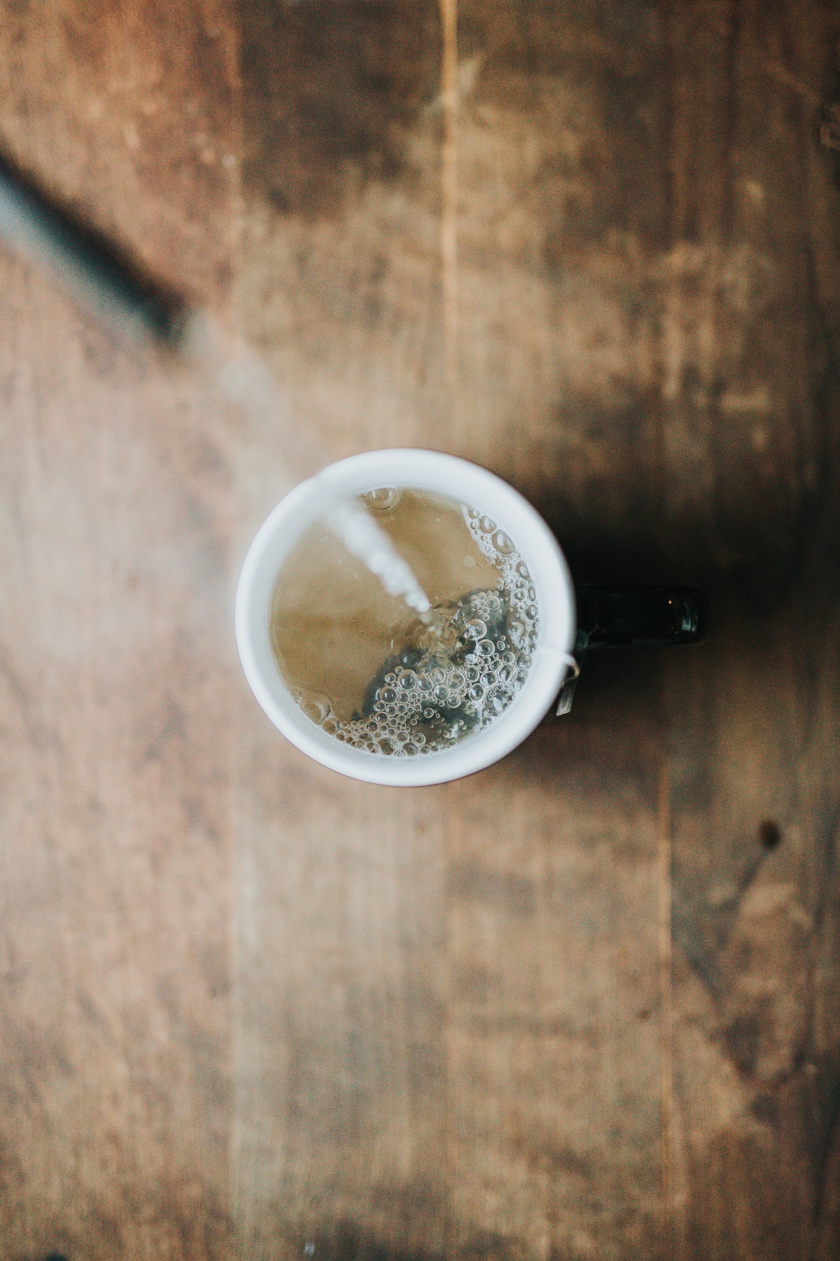 hot tea being poured into a cup